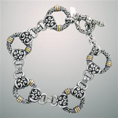 Ornate antiqued silver gold charm bracelet.                                                                                                                                                                                                               