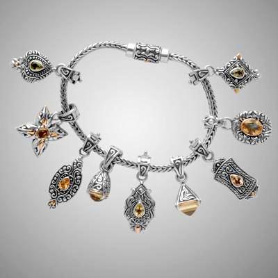 Silver foxtail bracelet loaded with charms.                                                                                                                                                                                                               