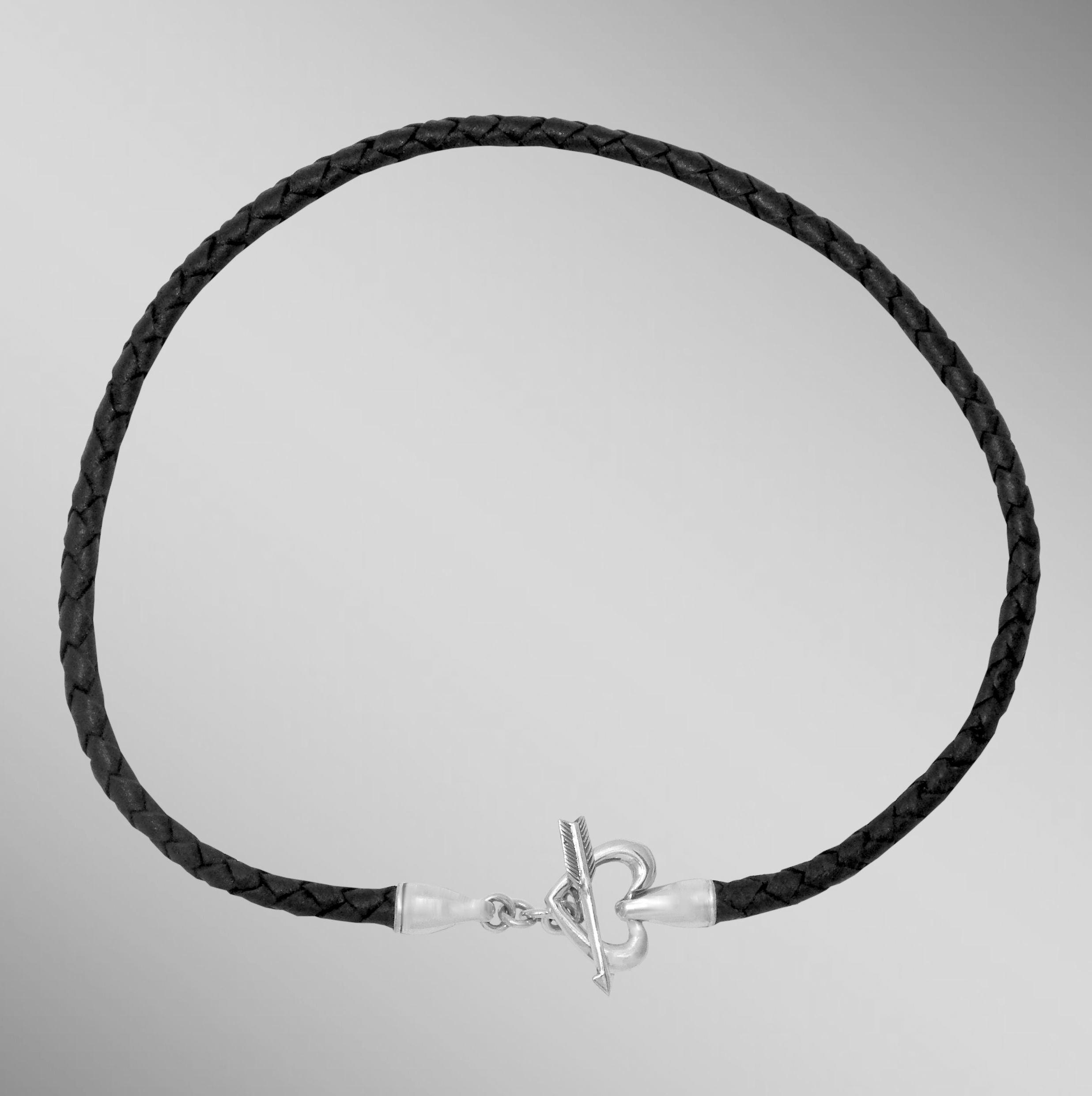 Black braided leather necklace with sterling silver heart and arrow toggle clasp.                                                                                                                                                                         